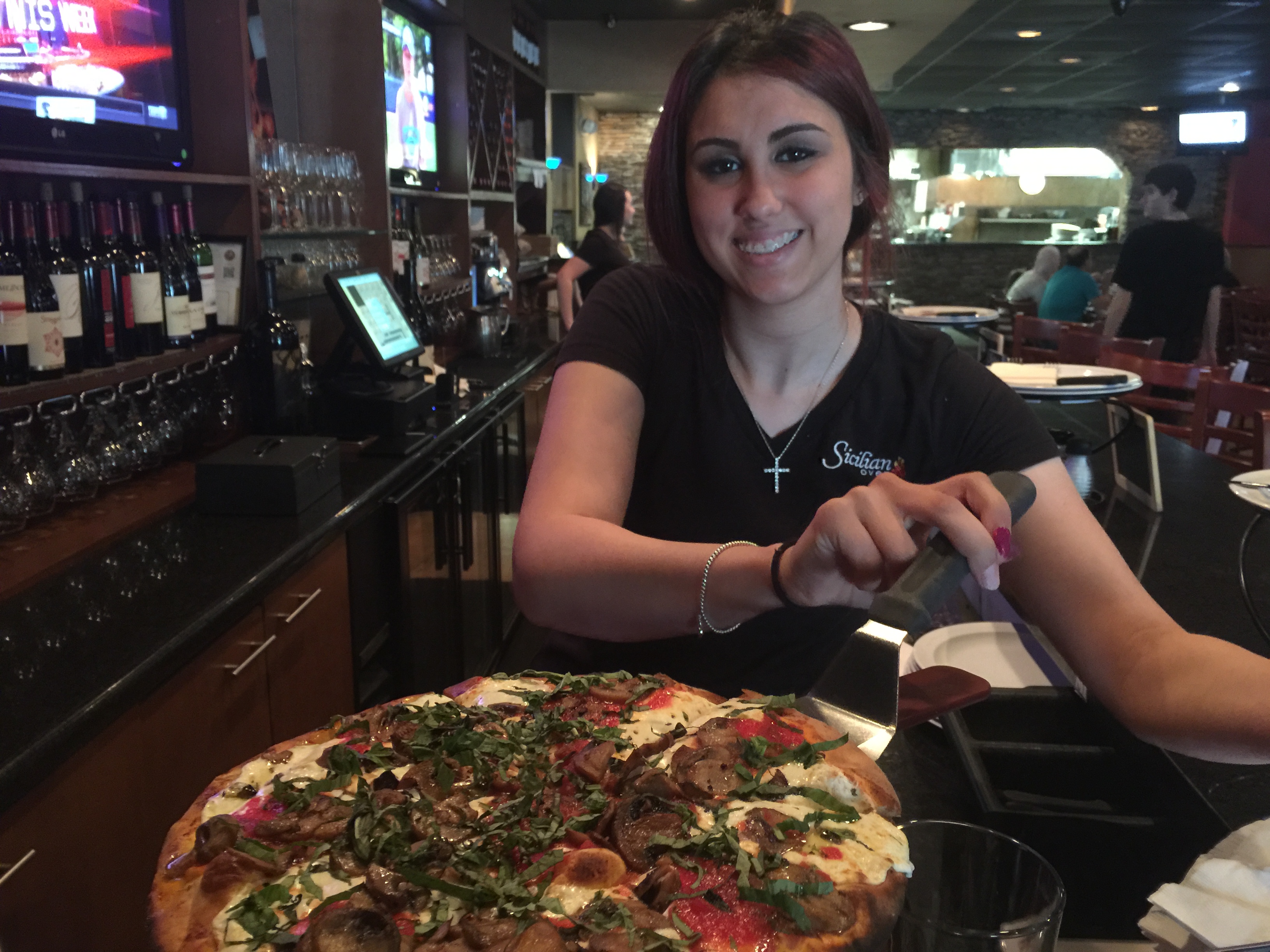 Our server Gina serving up The Boss Pie with mushrooms. 